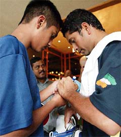 Indian cricketer Sachin Tendulkar signs an autograph 