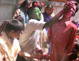 Physically handicapped  children smear colours on each other on the eve of Holi in Mumbai 
