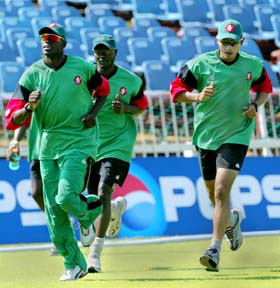 Kenya's Tony Suji Joseph Angara and Brijal Patel jog during a training session