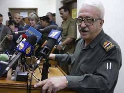 Iraqi Deputy Prime Minister Tariq Aziz addresses a news conference 