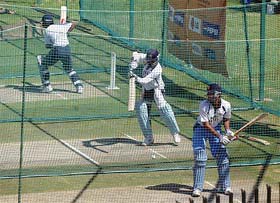 Indian players bat in the nets during a practice session