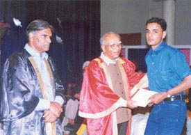 Mr Khushal Behl, Education Minister, gives away a prize to a student