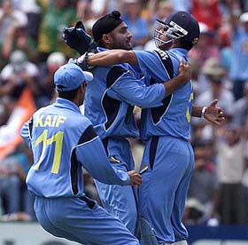Harbhajan Singh is congratulated by his team-mates Mohammad Kaif and Rahul Dravid after he dismissed Matthew Hayden
