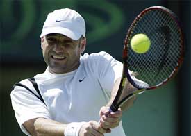 Andre Agassi of USA returns a serve against Jarkko Nieminen of Finland