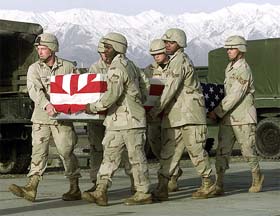 US soldiers carry a casket wrapped with a US flag during a casket transfer ceremony 