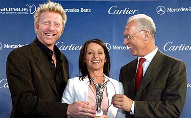 Boris Becker from Germany, Romanian gymnast Nadia Comaneci and Franz Beckenbauer pose for photographers