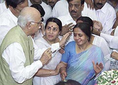 Deputy Prime Minister L.K. Advani consoles the grief-stricken widow of former Gujarat Home Minister Haren Pandya