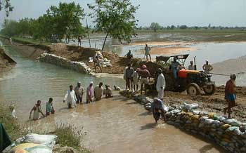 Residents of Bhokhra village try to repair the damaged portion