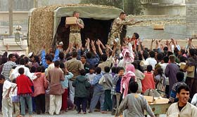 British light infantry and 2nd Royal Tank Regiment distribute humanitarian aid packages