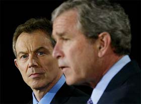 British Prime Minister Tony Blair listens as US President George W. Bush speaks to the media 