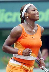 Serena Williams exults after defeating Kim Clijsters 