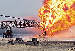 Firefighters fight an oil blaze in Gas-Oil Separation Plant Six in the Ramalya oil field, southern Iraq, as part of their ongoing support of Operation Iraqi Freedom. 