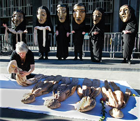 An anti-war protestor places a doll, representing a dead Iraqi child