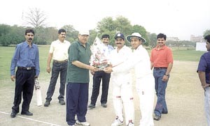 DDCA sports secretary Sunil Dev being received by the players before the inauguration of the Devender Singh Memorial Cricket