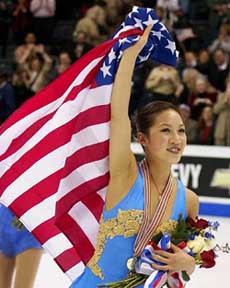 Michelle Kwan of the USA waves an American flag after winning the gold medal at the World Figure 