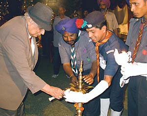 The Punjab Governor, Lieut-Gen J. F. R. Jacob (retd), lights a lamp to inaugurate a function
