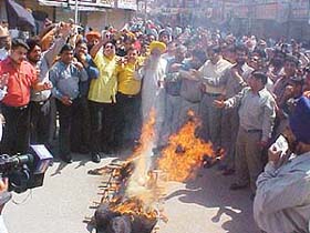 Traders burn an effigy of VAT