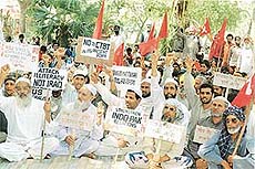 CPI and CPM activists carry anti-war placards