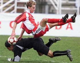 Canadian striker Cam Wilson flies over Mexican goaltender
