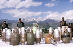 Army personnel display grenades seized from militants