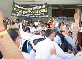Traders gherao Mr M.K. Zutshi, Chairman of the Central Board of Excise and Customs, at Ludhiana Railway Station on Tuesday.