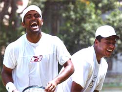Tennis stars Leander Paes and Mahesh Bhupathi share a light moment during a practice session