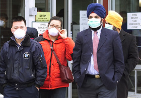 People wearing protective masks leave after being examined at the second Toronto area SARS clinic