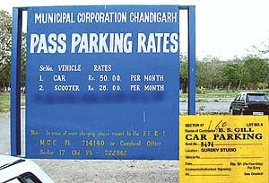 The contractor of a parking lot opposite Regional Computer Centre, Sector 17-B, has wiped off the permitted MC parking rates (per entry) for cars and scooters. The actual rate is Rs 2.50 for a car and Re 1 for a scooter; and inset: Parking slip