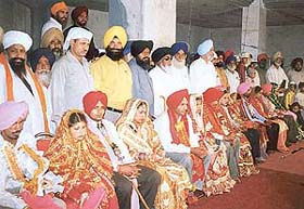 Newly married couples at a mass marriage ceremony at Sodhi Sahib Gurdwara in Sahnewal 