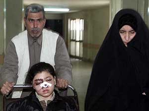 An injured Iraqi girl is brought to a Baghdad hospital by her parents 