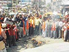 Activists of the local unit of the Shiv Sena  burn an effigy of Finance Minister Jaswant Singh in protest against VAT