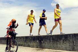 Clinton Clarke, 35, of Georgetown, share a light moment with member of Australia's cricket team