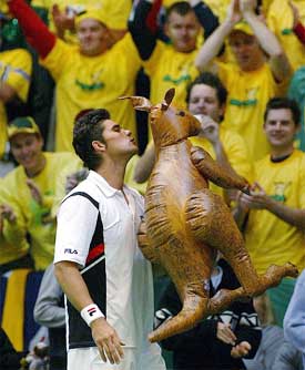 Australia's Mark Philippoussis kisses a kangaroo after beating Sweden's Jonas Bjorkman