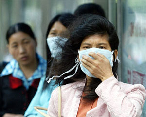 Chinese women wear masks at Guangzhou, capital of Guangdong