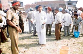 Residents offer water to members of a rescue team at the site of the crash 