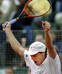 Argentine Gaston Gaudio celebrates his 6-4 6-0 6-2 victory