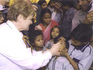 Dr Groharlem Bruntland, Director-General of the World Health Organisation, administers polio drop