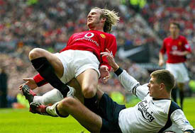 Manchester United's David Beckham is fouled by Liverpool's Steven Gerrard 