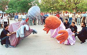Members of the CEVA group present a puppet show against the Iraq war in Sector 17