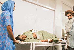 Swaranjeet Kaur, a victim of the Ambala plane crash, lying on a stretcher with splinter injuries 