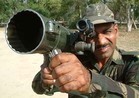 An Armyman demonstrates a weapon during a display at the cantonment in Bathinda 