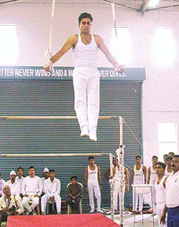 An ITBP gymnast demonstrates the Roman rings event at the inauguration of a new gymnastics hall at the ITBP centre