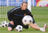 Manchester United's David Beckham stretches during a training session 