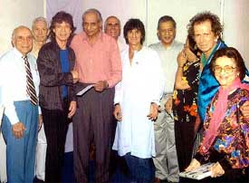 Rolling Stones' lead singer Mic Jagger along with his band members present a cheque worth Rs 25 lakh for the welfare of the Cricket Club of India's cricket academy to CCI president Raj Singh Dungarpur 