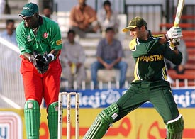 Pakistan's Shoaib Malik cuts a delivery as Kenyan wicket-keeper Kennedy Obuya looks on 