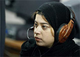 Rita Durang of Afghanistan listens to internet music at the Kabul University 