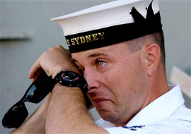 Leading Seaman Paul Tucker speaks to his wife Tania on his mobile phone at the Garden Island Navy base near Sydney after Australia deploys HMAS Sydney to the Gulf on Tuesday