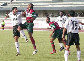 JCT Phagwara�s Joe Paul Ancheri is being challenged by Mohun Bagan defender Yakubu as Hardip Gill looks on 