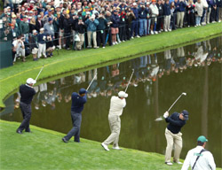 The foursome of Mark O'Meara, Tiger Woods, John Cook and Tom Watson try to skip balls over a pond 