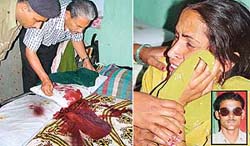 Police officials examine the blood-soaked bed on which constable Maman Chand 